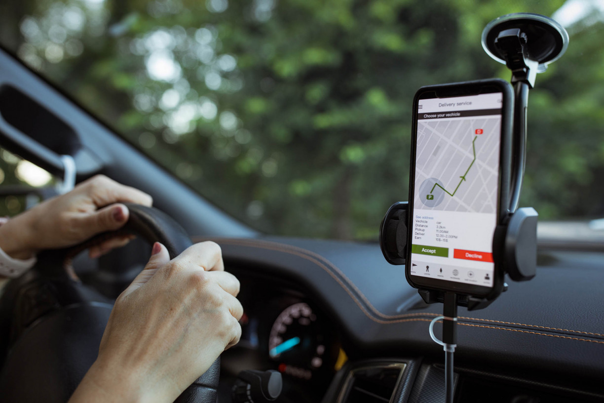 Gig worker reviewing a delivery route and business mileage